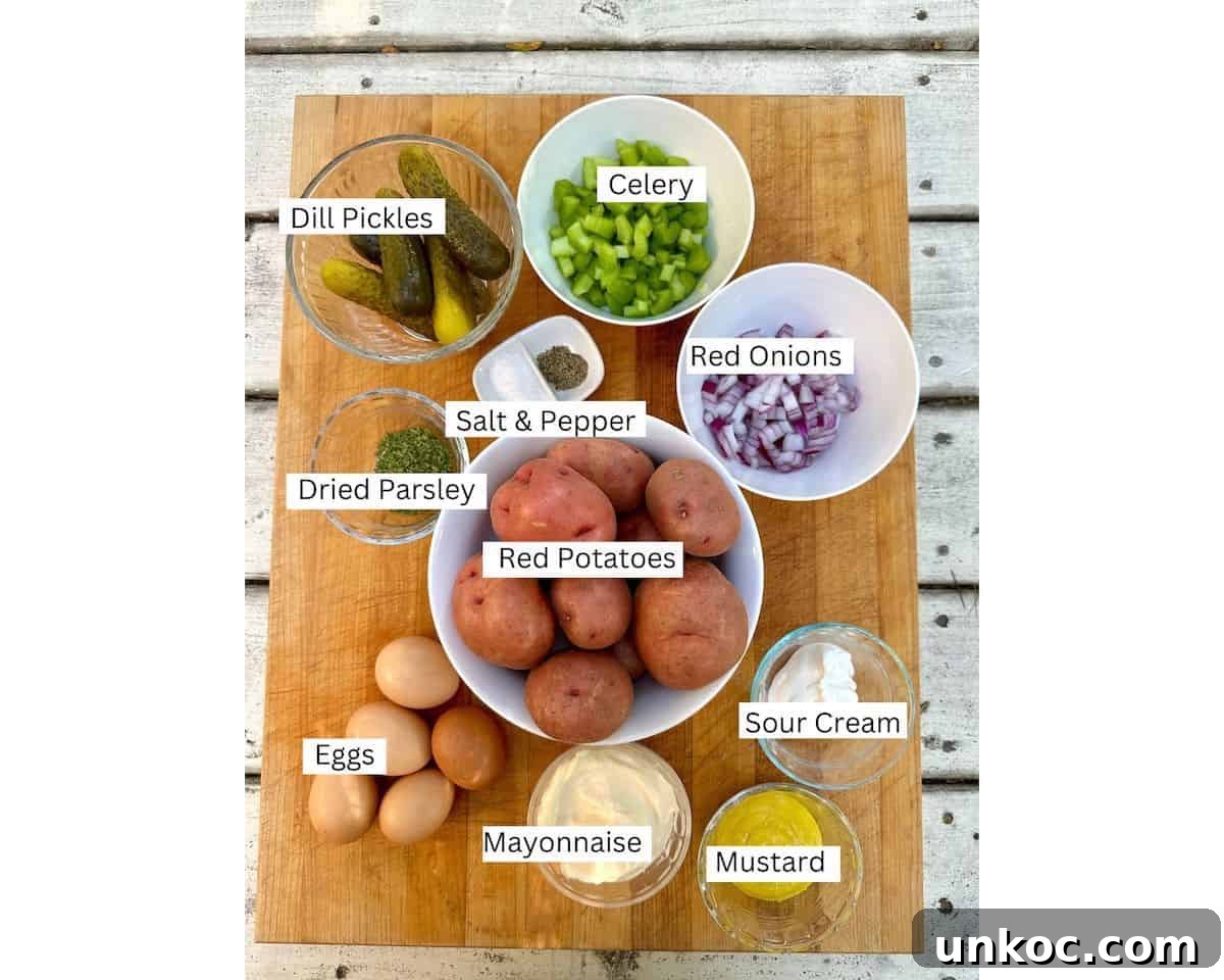 Creamy Red Potato Salad with Herbs and Dijon 3 Red potato salad ingredients on a cutting board with labels on each ingredient.