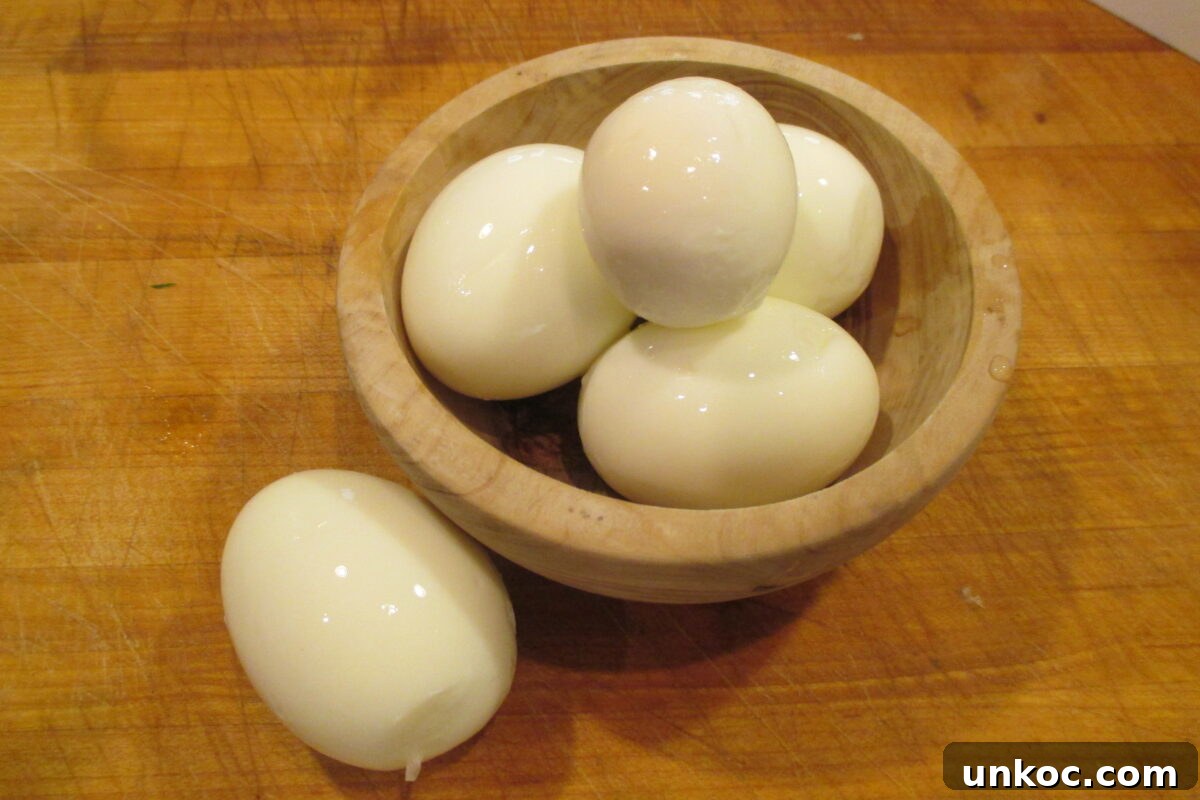 Creamy Red Potato Salad with Herbs and Dijon 5 Hard boiled eggs in wooden bowl.