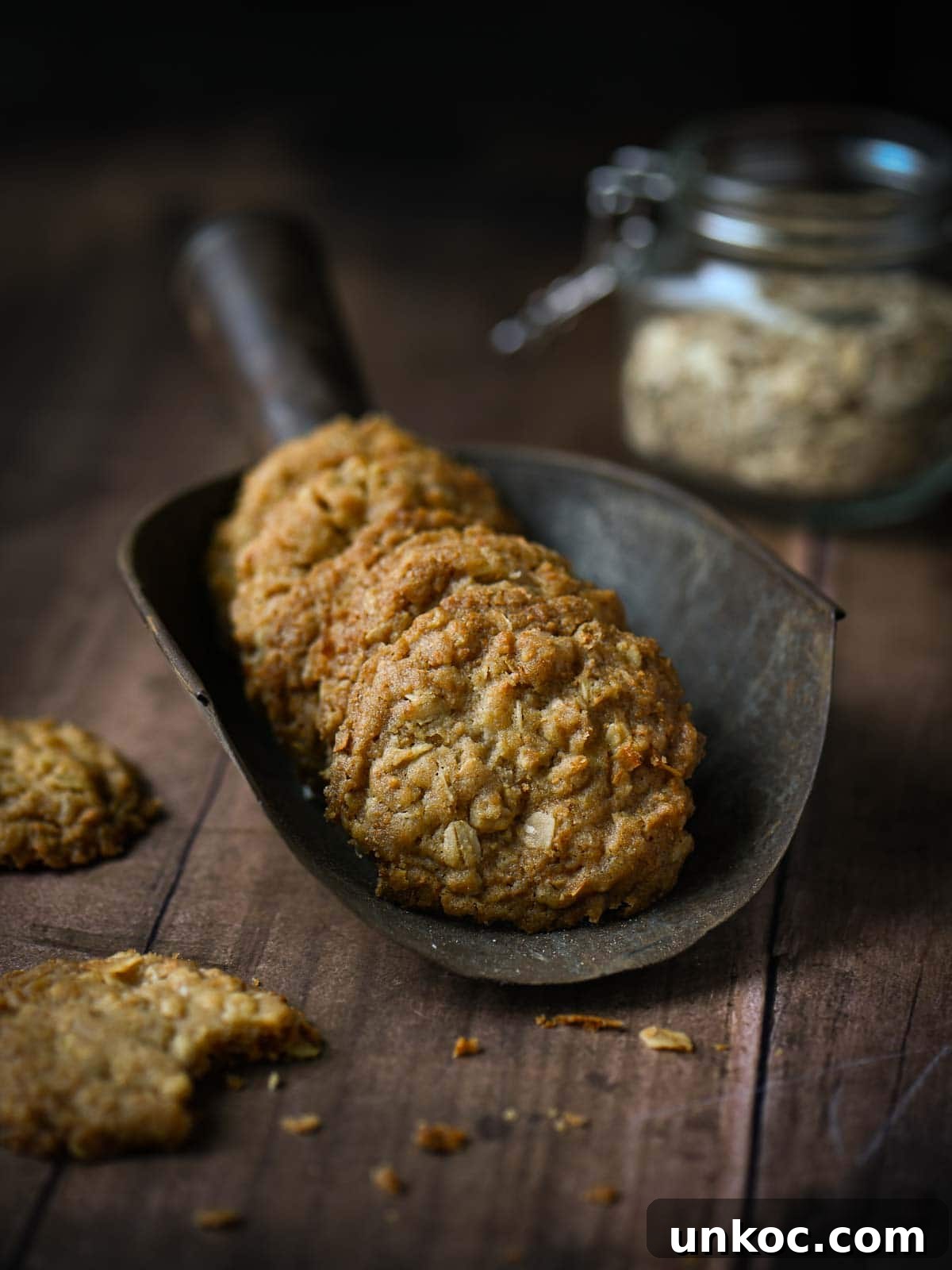 Oatmeal cookies in a large metal scoop.
