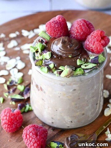 Close-up of Nutella overnight oats with raspberries and pistachios.