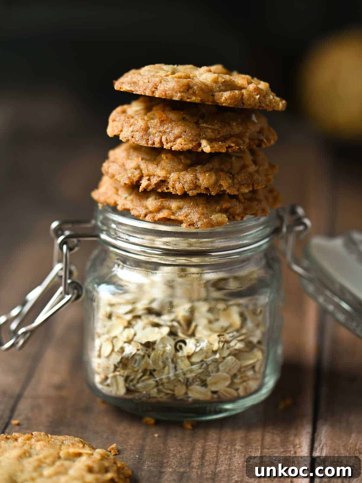 Cookies stacked on a jar of oatmeal.