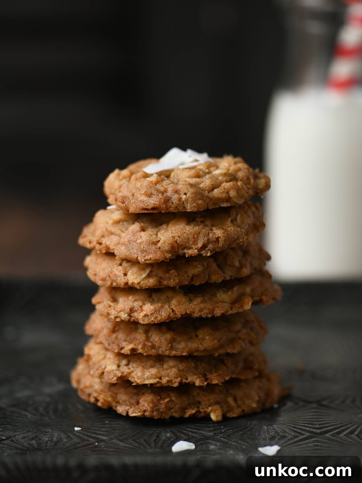 A stack of oatmeal cookies on a tin tray.