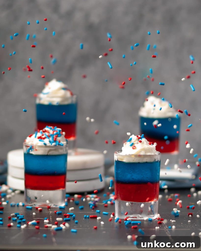 5 Ingredient Red White and Blue Jello Shots 2 Red White and Blue Jello Shots with Sprinkles Flying in the Air