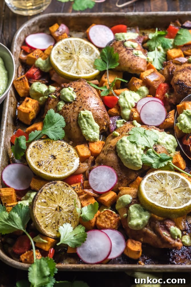 Roasted sheet pan chili-lime chicken with sweet potatoes and vegetables.
