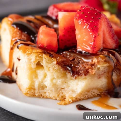 Churro cheesecake bar topped with caramel sauce, chocolate sauce, and strawberries featured image.