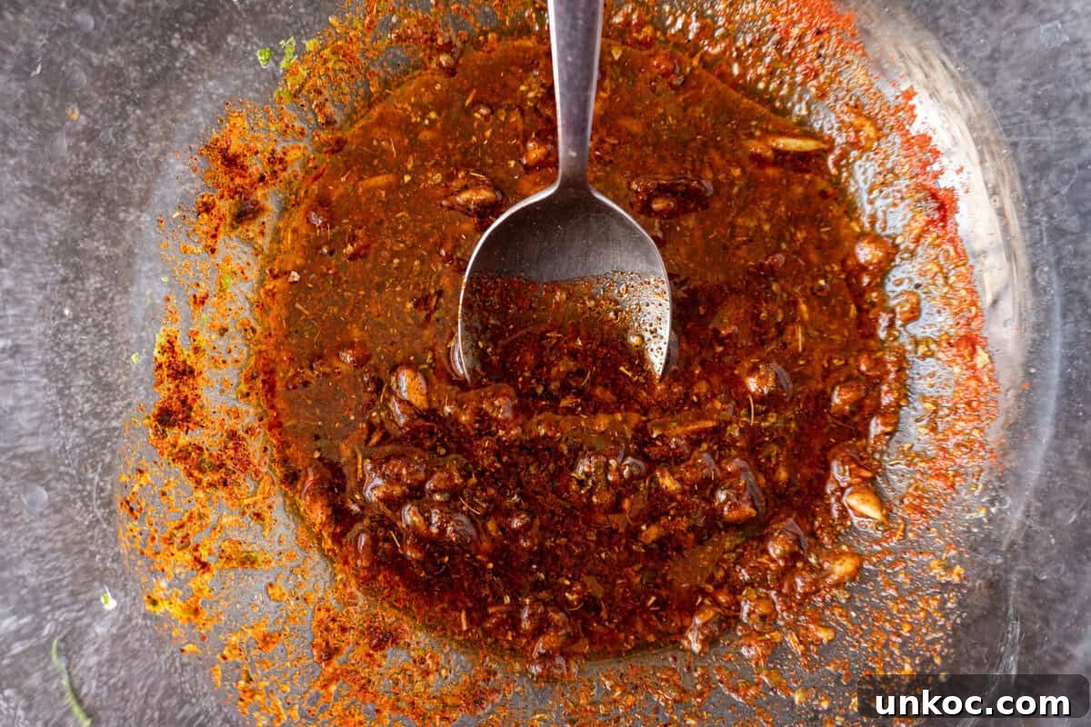 Steak marinade mixed together in a clear glass bowl.