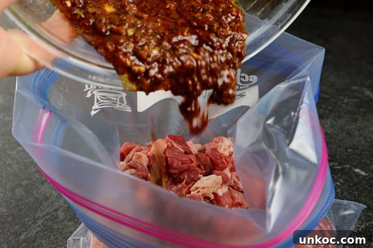 Adding marinade to a bag filled with chopped meat.
