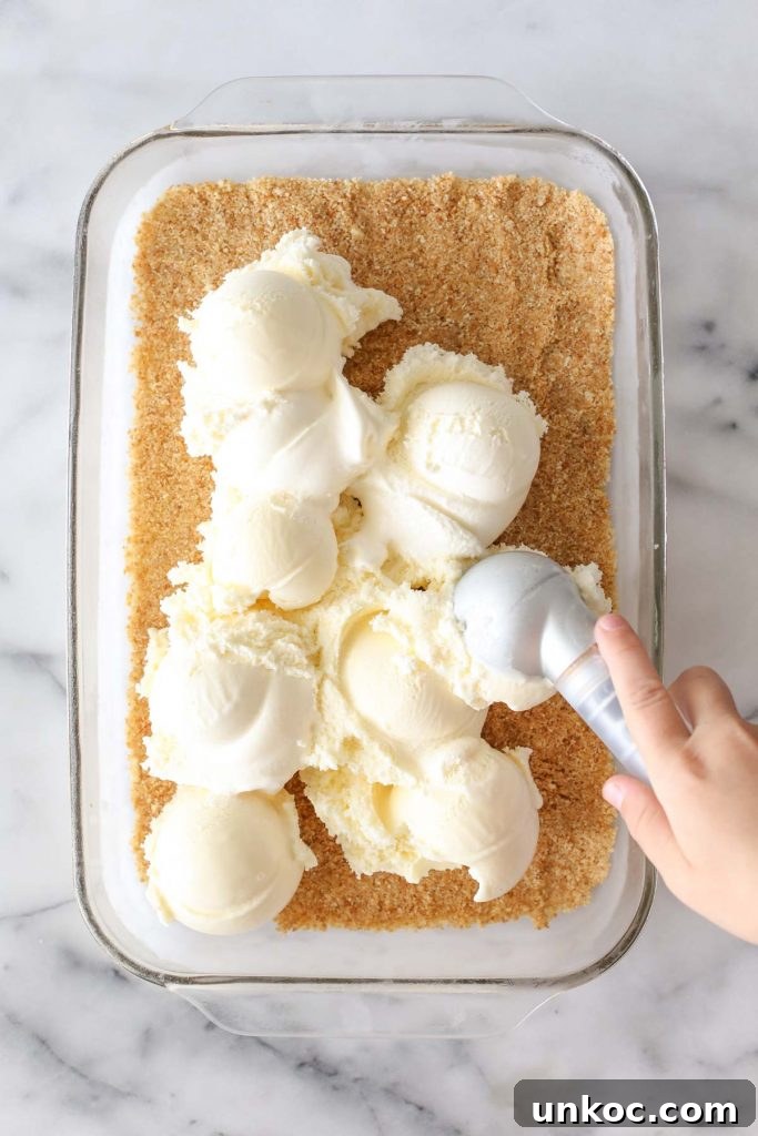 Peanut Buster Ice Cream Dessert Recipe 5 Melted butter being mixed into Nilla wafer crumbs.