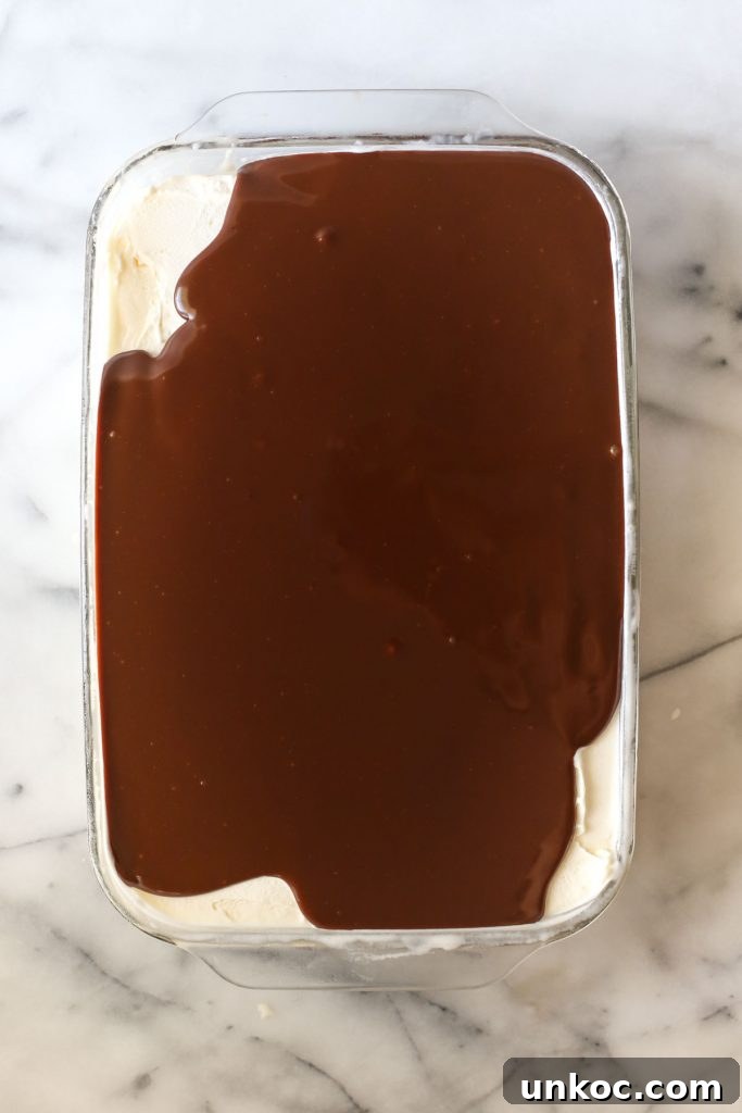 Peanut Buster Ice Cream Dessert Recipe 9 Chocolate fudge topping cooking in a saucepan.