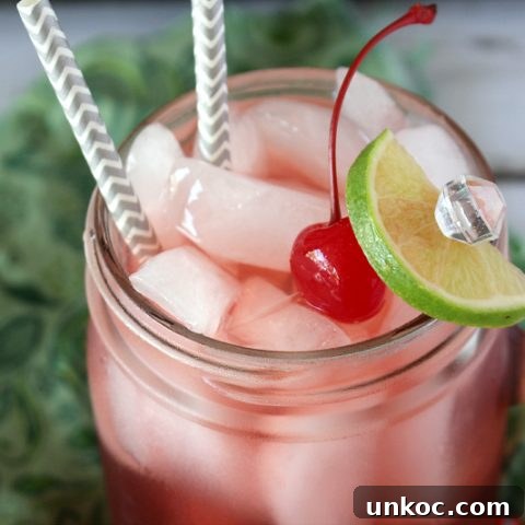 glass of boozy cherry limeade