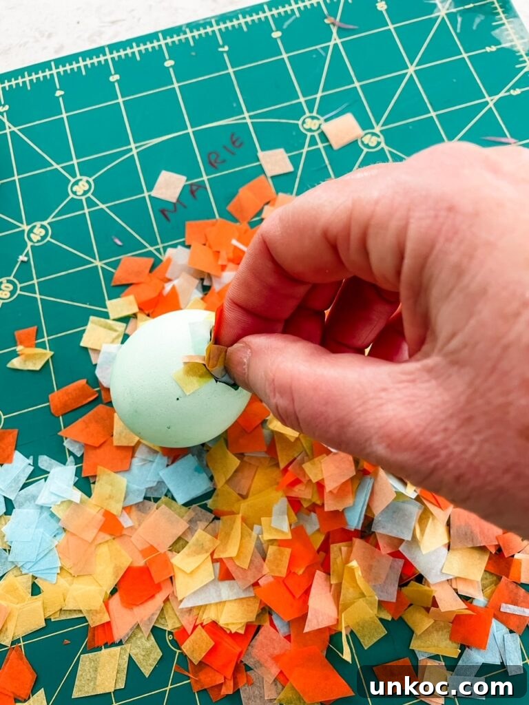 DIY Confetti Easter Eggs for Easter Crafts 9 The confetti pieces being placed in the eggshell