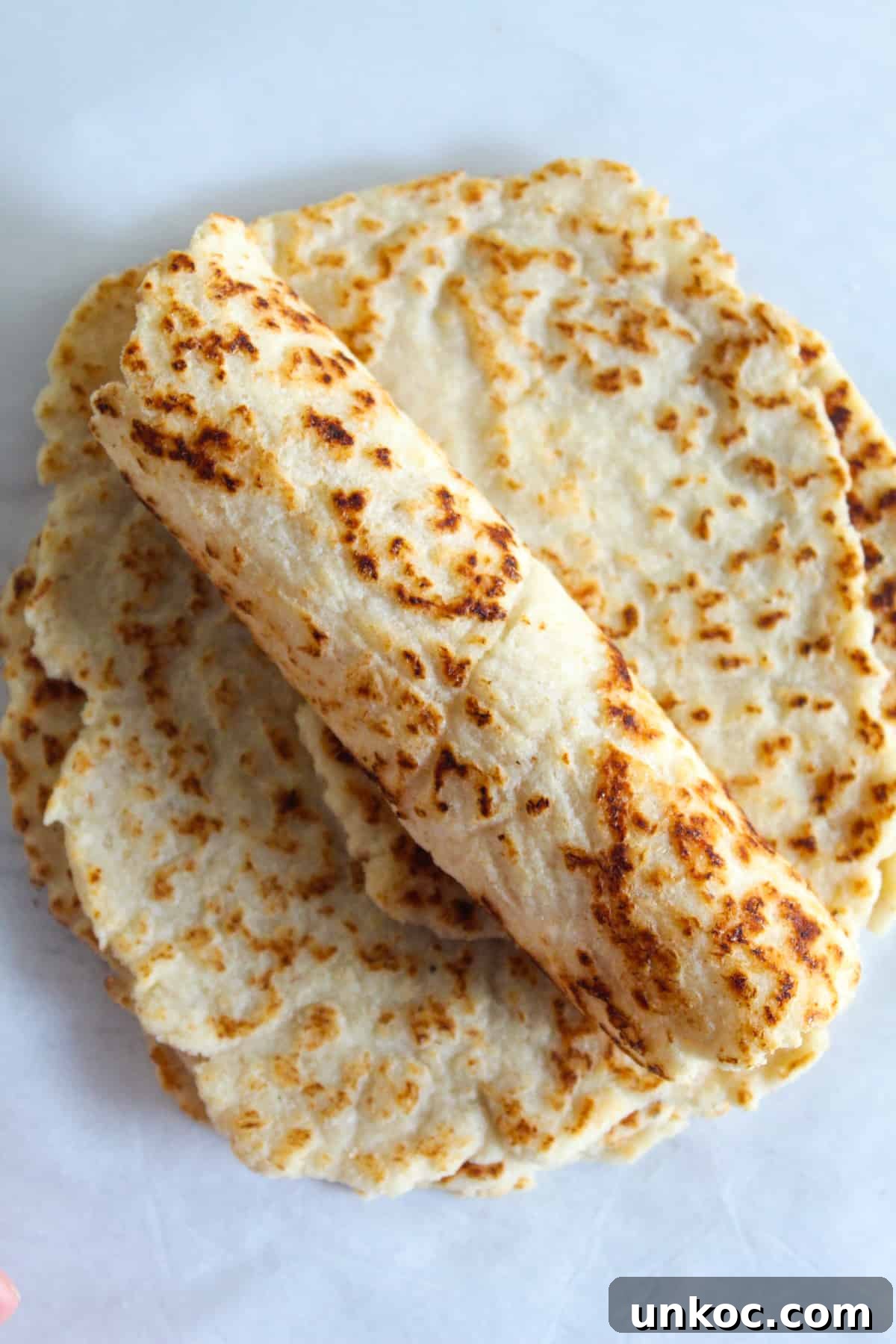Soft Keto Almond Flour Tortillas That Fold Without Cracking 18 Almond Flour Tortillas Rolled on a Counter.