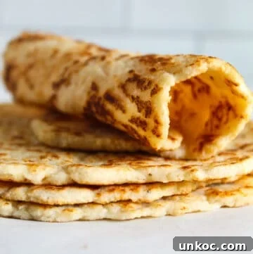 Soft Keto Almond Flour Tortillas That Fold Without Cracking 4 rolled almond flour tortilla sitting on a stack of tortillas