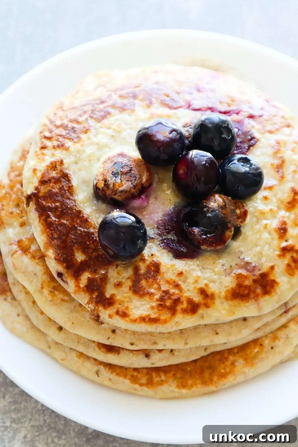 Flourless Blueberry Oatmeal Pancakes No Banana 2 Flourless blueberry oatmeal pancakes made with oats, yogurt, egg, honey, vanilla and blueberries for a quick healthy breakfast.