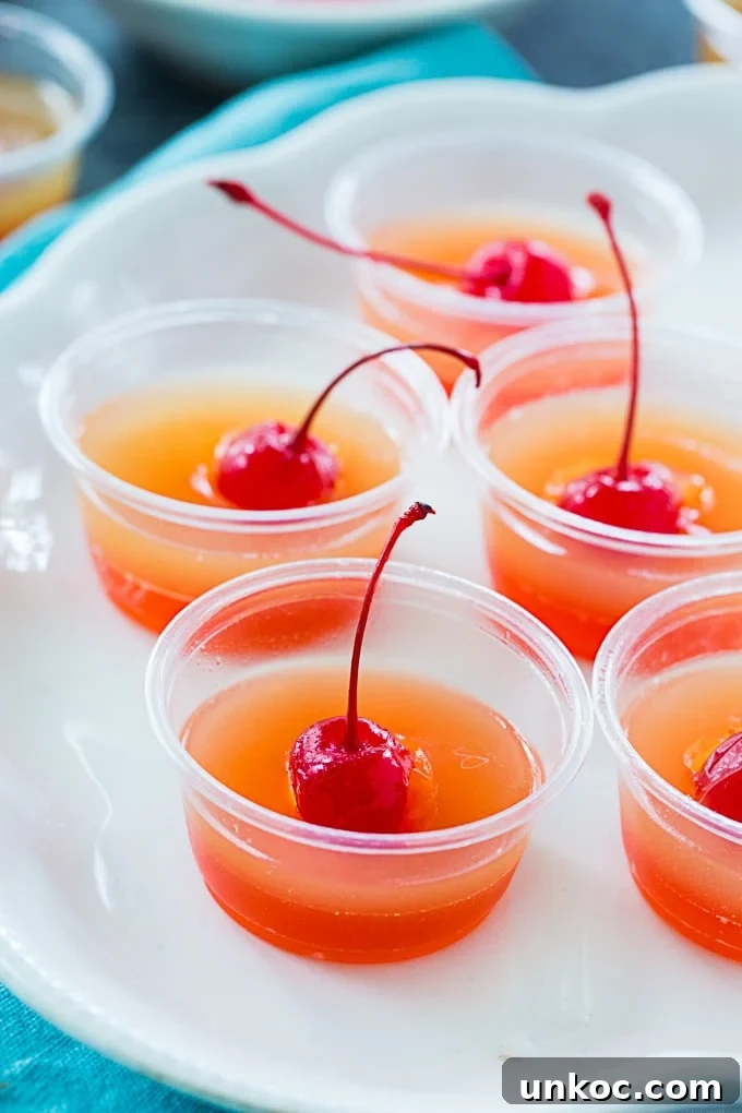 Pineapple Upside-Down Cake Jello Shots for Summer Parties 5 Jello shots in plastic cups.
