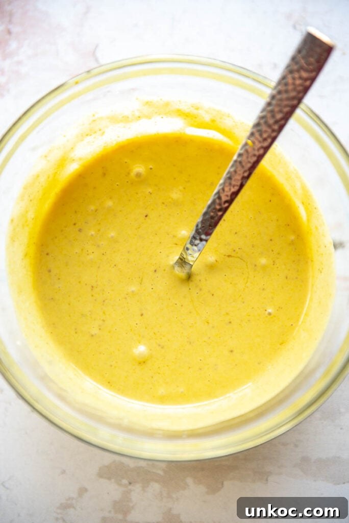 Slow Cooker Honey Mustard Chicken Recipe 5 honey mustard sauce in a bowl with spoon