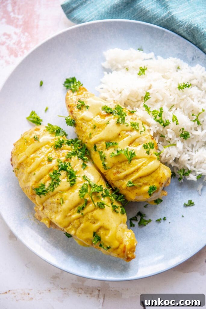 Slow Cooker Honey Mustard Chicken Recipe 8 two honey mustard chicken breasts on a plate with mashed potatoes