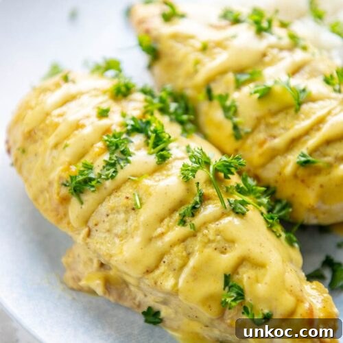Slow Cooker Honey Mustard Chicken Recipe 10 two honey mustard chicken breasts on a plate