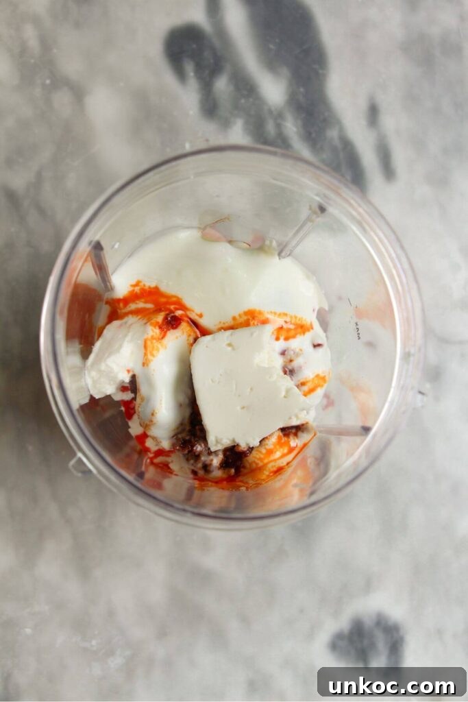 Spicy Harissa Whipped Feta Dip 4 Ingredients for spicy feta dip in a blender.
