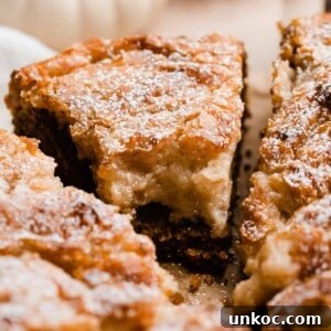 Pumpkin Gooey Butter Cake Recipe 11 A close-up on a slice of pumpkin gooey butter cake with a bite missing.