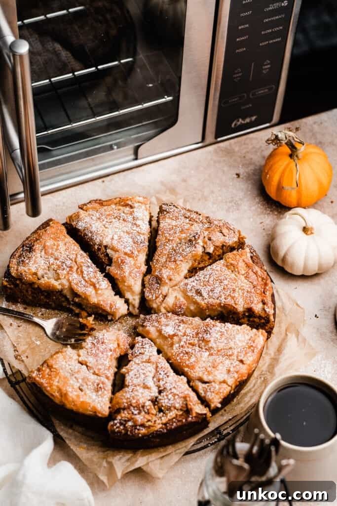 Pumpkin Gooey Butter Cake Recipe 9 Sliced pumpkin gooey butter cake with the air fry oven in the background.