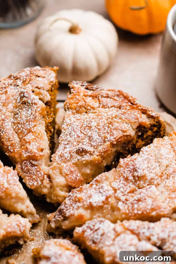 Pumpkin Gooey Butter Cake Recipe 10 Slices of pumpkin gooey butter cake with mini pumpkins and coffee mugs.