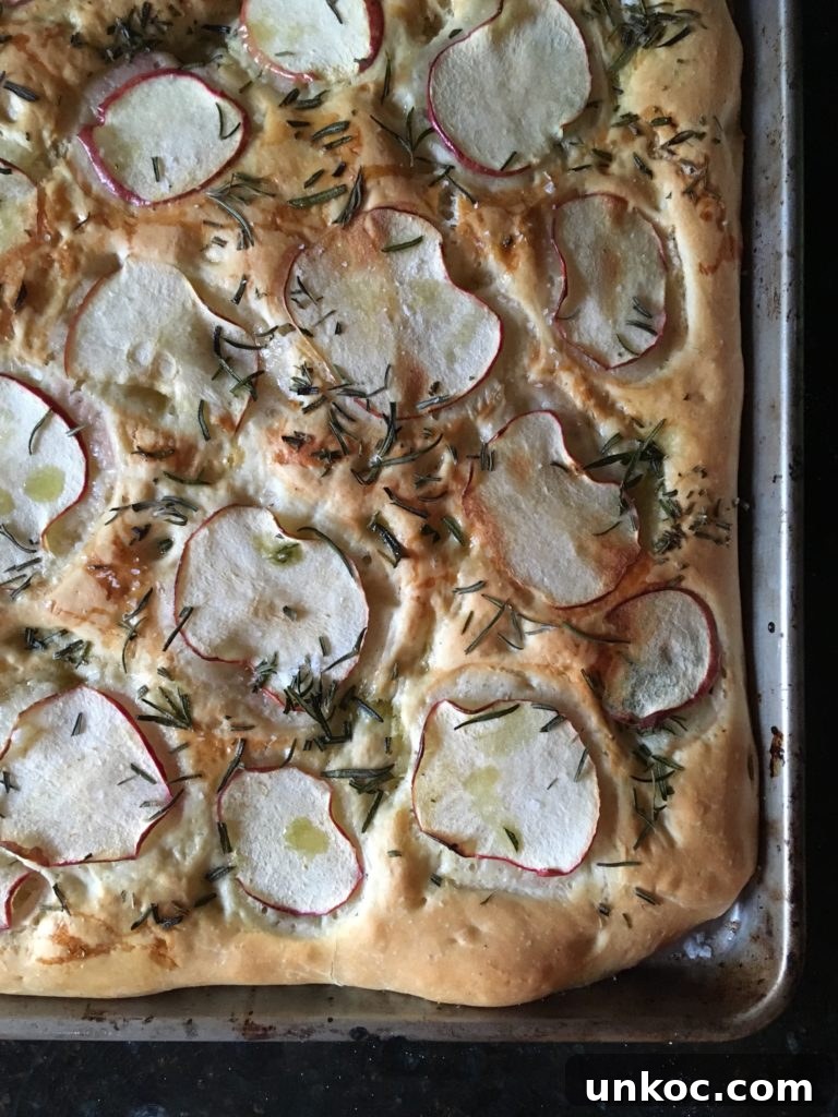 Apple Rosemary Focaccia Recipe 2 Apple and rosemary focaccia topped with sliced apples, rosemary, honey, olive oil, and flaky sea salt