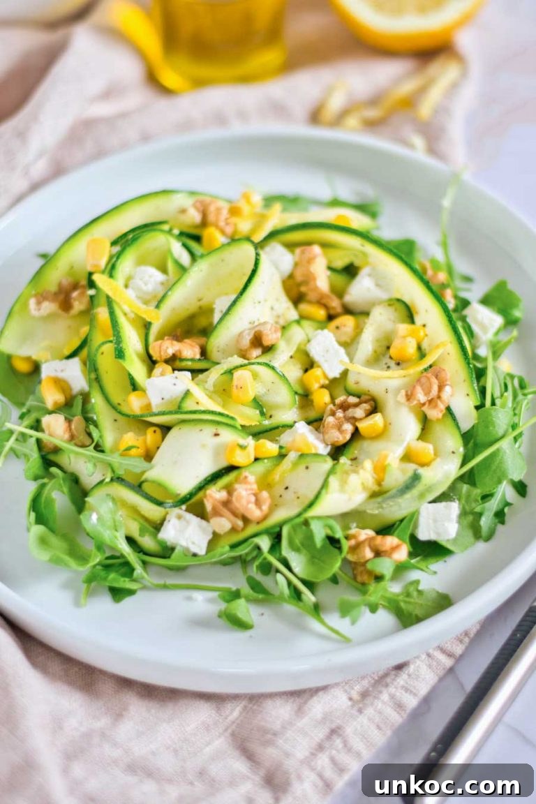 Fresh Summer Zucchini Salad with Lemon and Herbs 5 A closeup view of zucchini and corn salad with walnuts and feta.