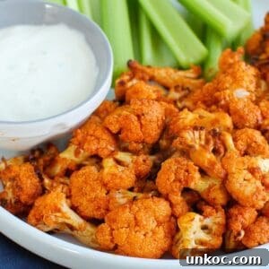 Crispy Air Fryer Buffalo Cauliflower Bites 6 Air Fryer Buffalo Cauliflower on white plate