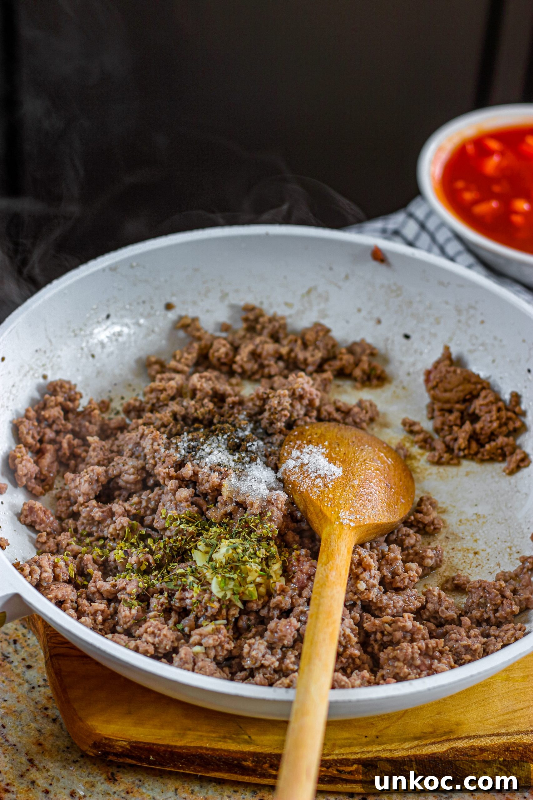 Poor Mans Husband Casserole with Ground Beef 9 Ground beef cooking in a skillet for casserole