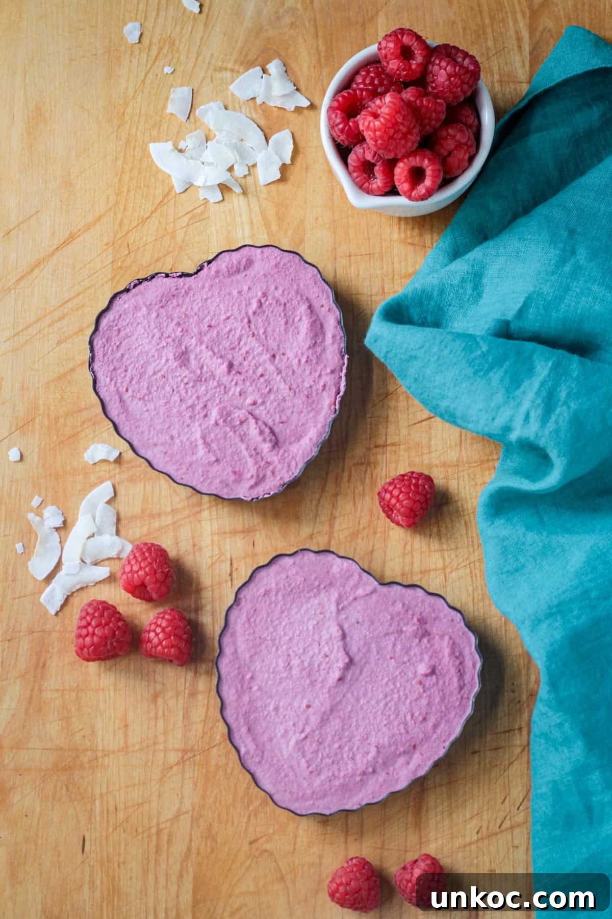 Vegan Raw Raspberry Cheesecake Recipe 6 Two heart shaped tart pans filling with raspberry cheesecake.