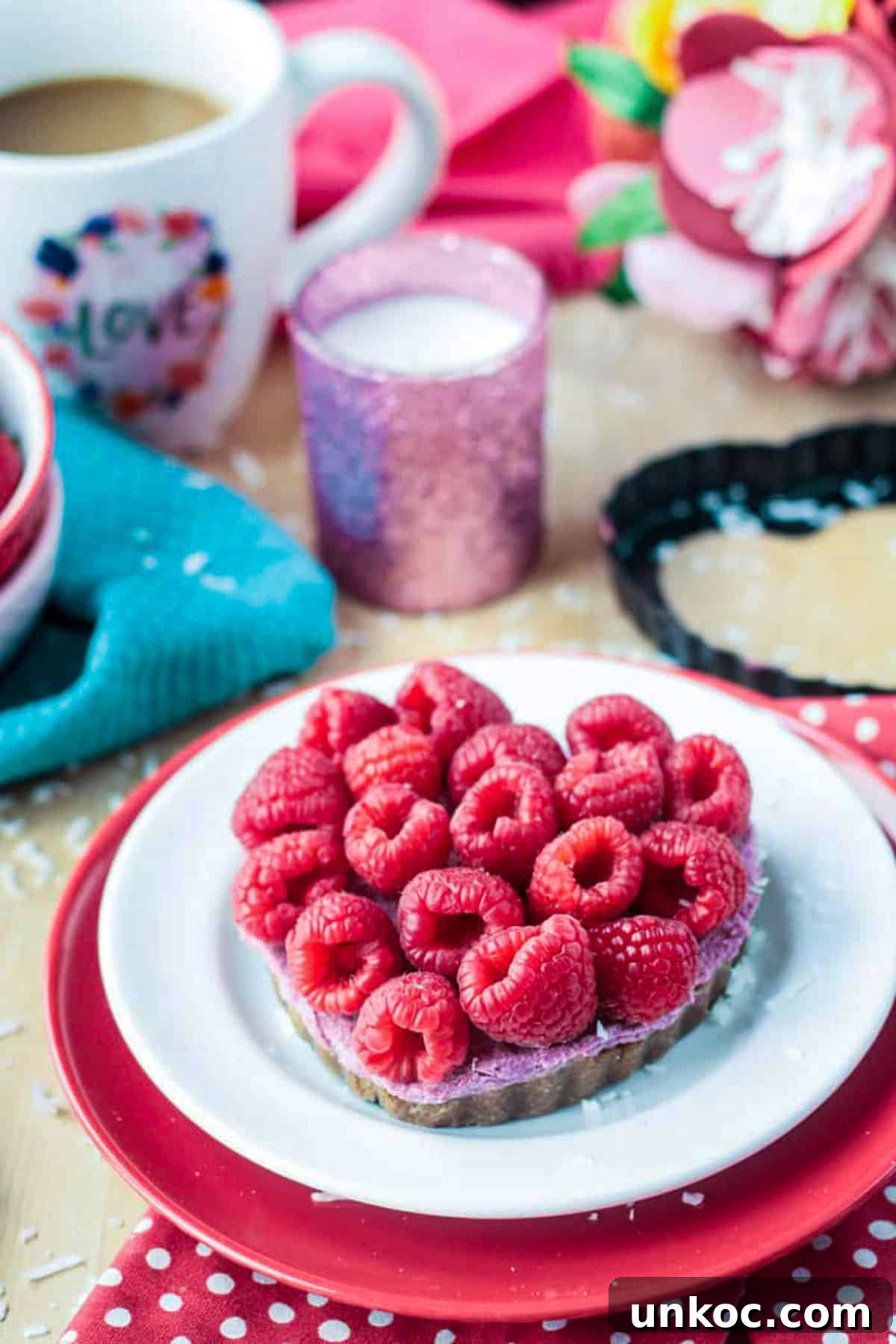 No Bake Vegan Raspberry Cheesecake Tarts Fresh raspberries covering the top of a heart shaped tart.