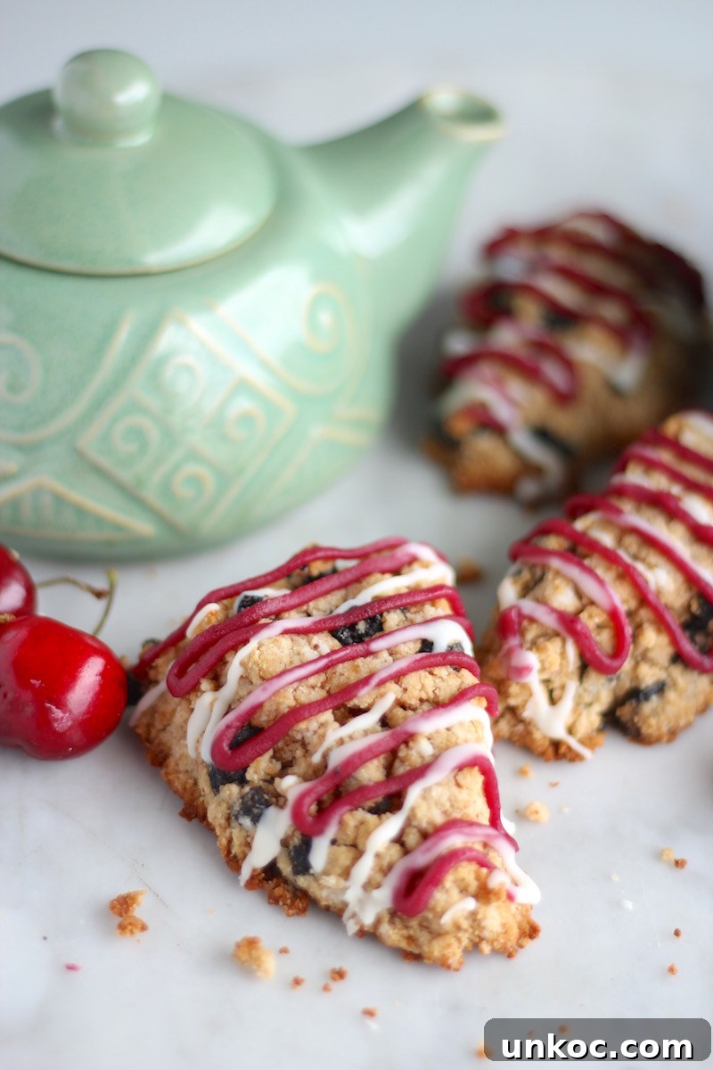 Paleo Frosted Cherry Scones (AIP) - luscious dried cherry scones are drizzled with a fresh cherry and coconut butter glaze for a totally delicious treat! | fedandfulfilled.com