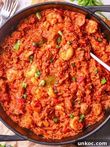 A pan of shrimp and sausage jambalaya, packed with vibrant colors, bold Cajun spices, and hearty ingredients on a tabletop.