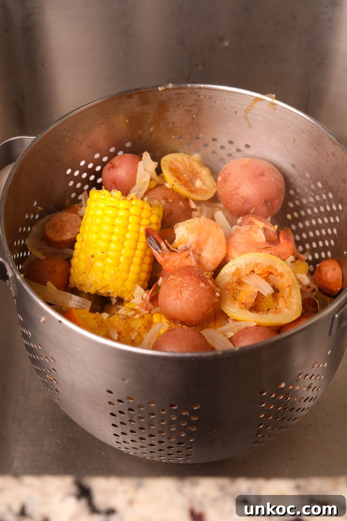 Cajun Shrimp Boil with Corn and Potatoes 6 shrimp boil draining in a colander.