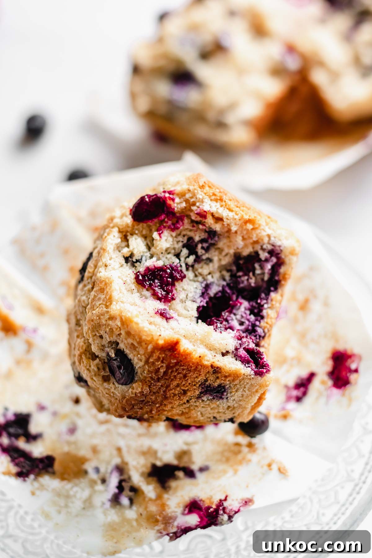 One blueberry muffin with a bite removed.