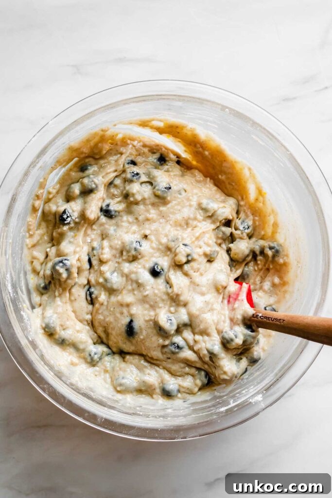 Blueberries get folded into the muffin batter.