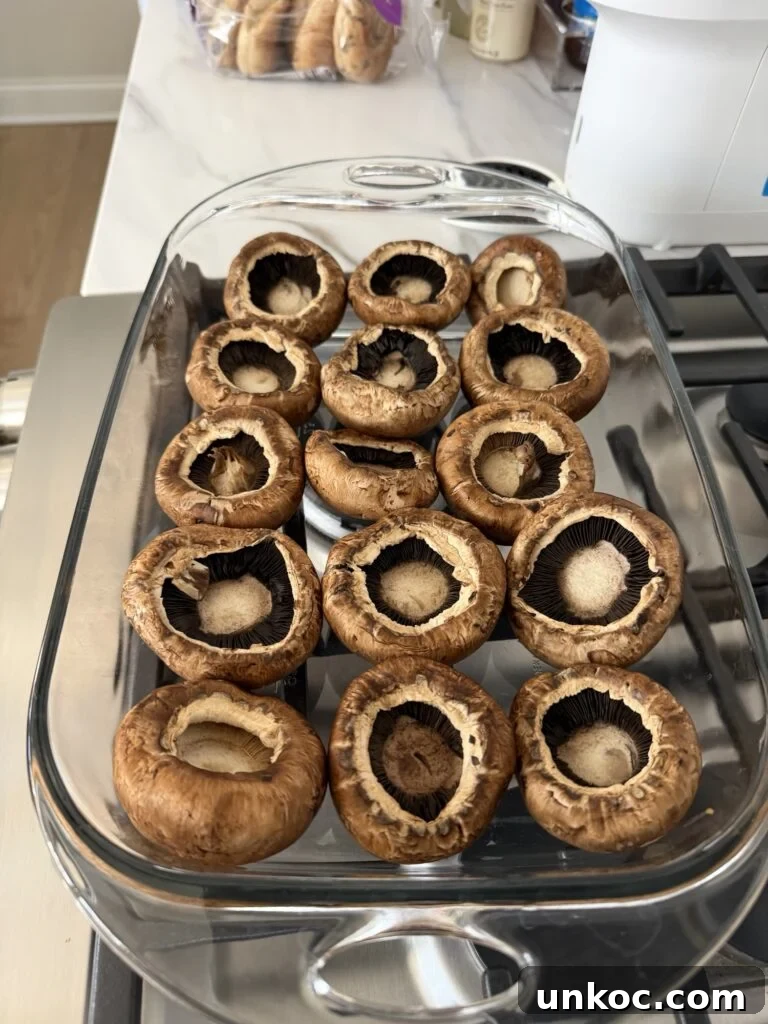 Mushroom caps upside down in a baking dish
