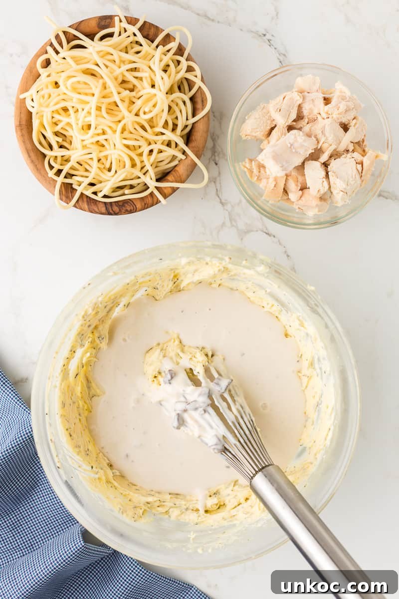 Chicken Tetrazzini with Cream of Mushroom Soup 6 Broth mixture is added to the cream cheese combination in bowl with whisk.