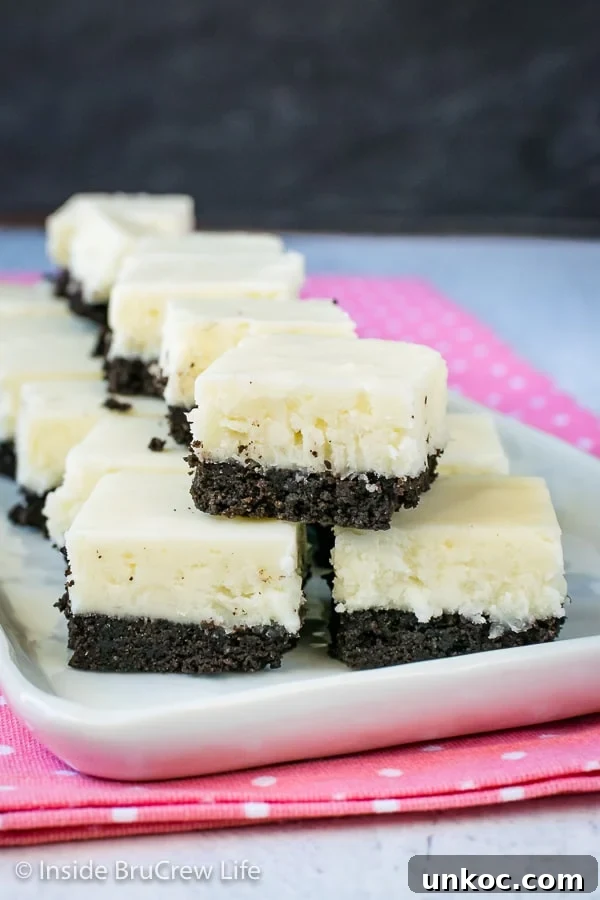 Coconut Oreo Fudge - three times the coconut and a cookie crust makes this no bake dessert so good. Make this easy recipe for spring or summer parties. #fudge #coconut #Oreocookies #nobake #spring #Easter #dessert #coconutcream Multiple pieces of white coconut fudge with an oreo cookie base on a white plate.