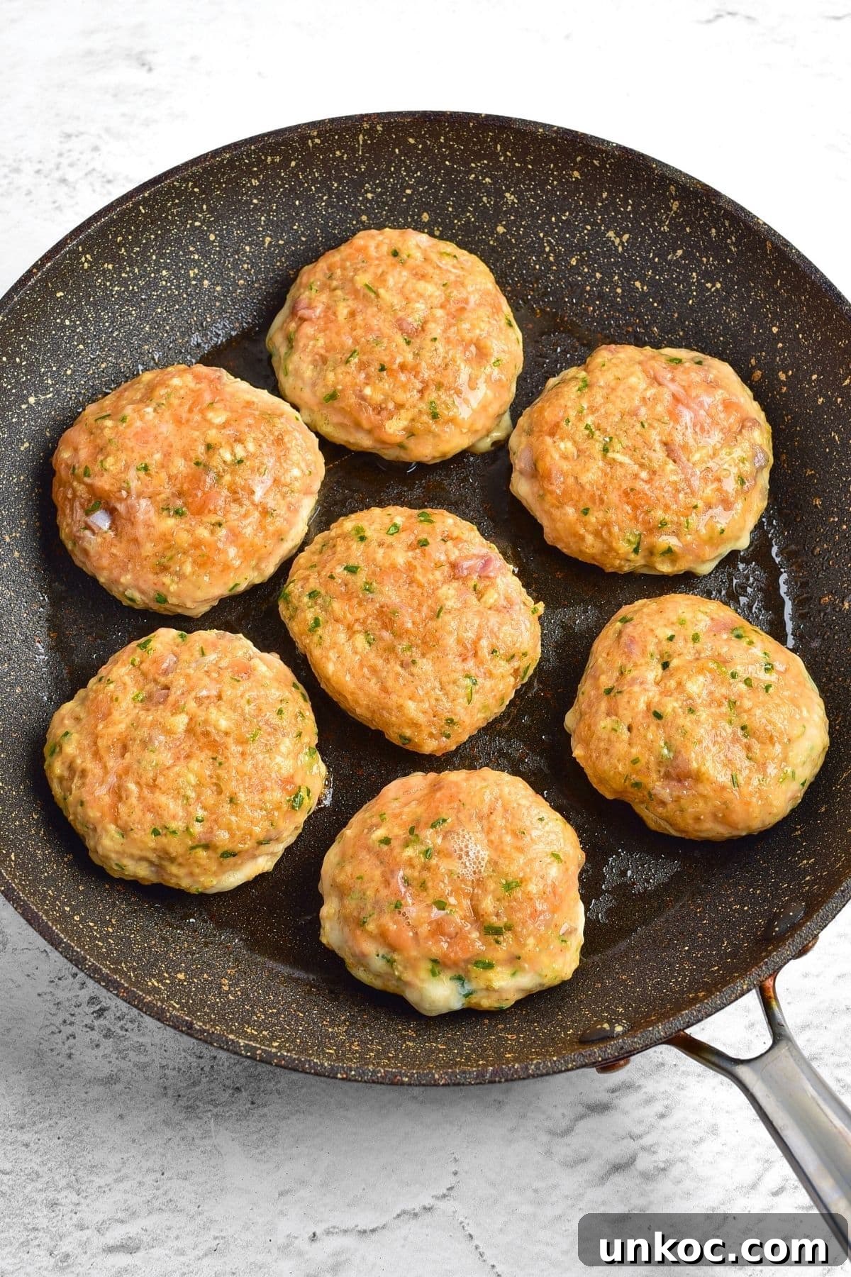 Cooking salmon patties in skillet.