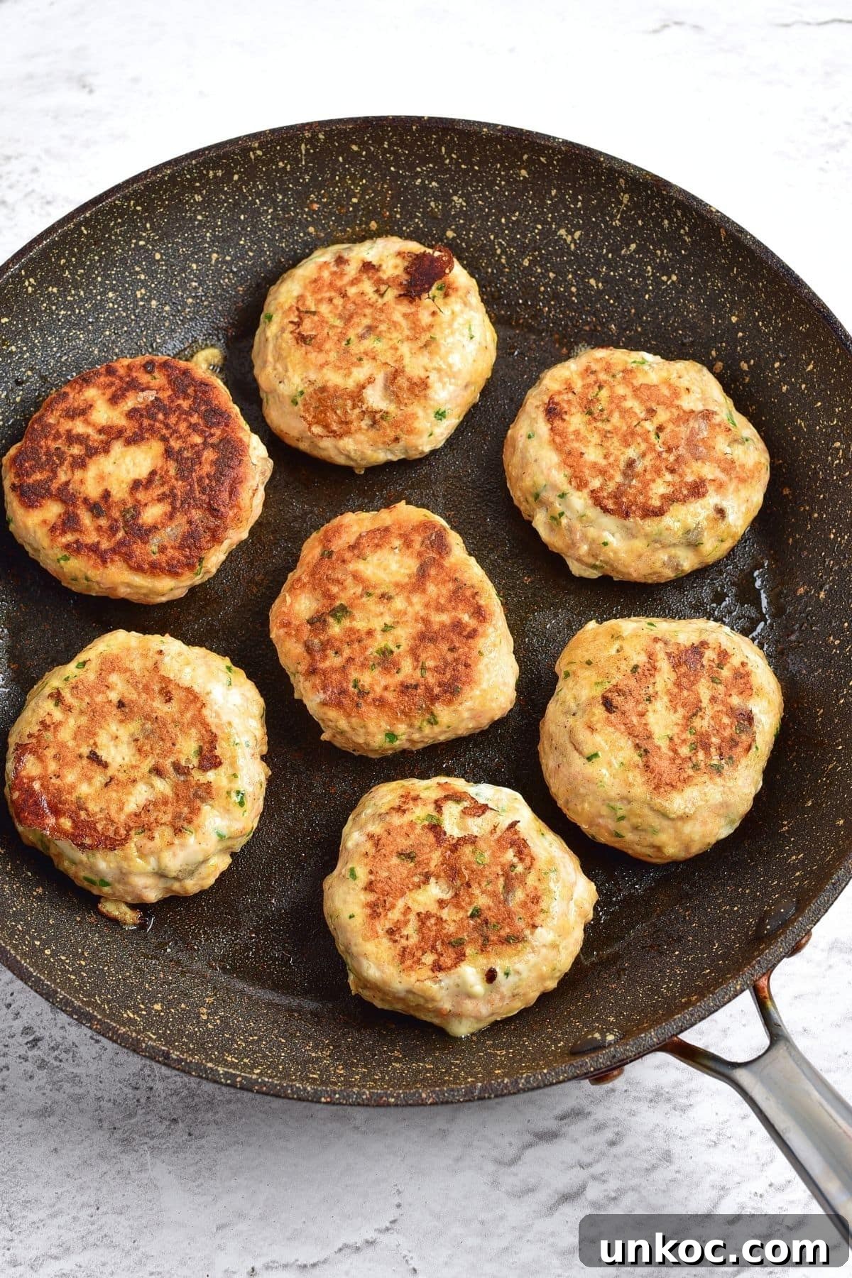 Cooked salmon cakes in skillet
