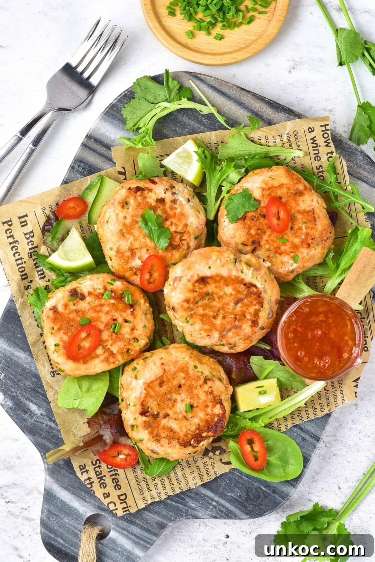 Thai salmon fish cakes on parchment paper.