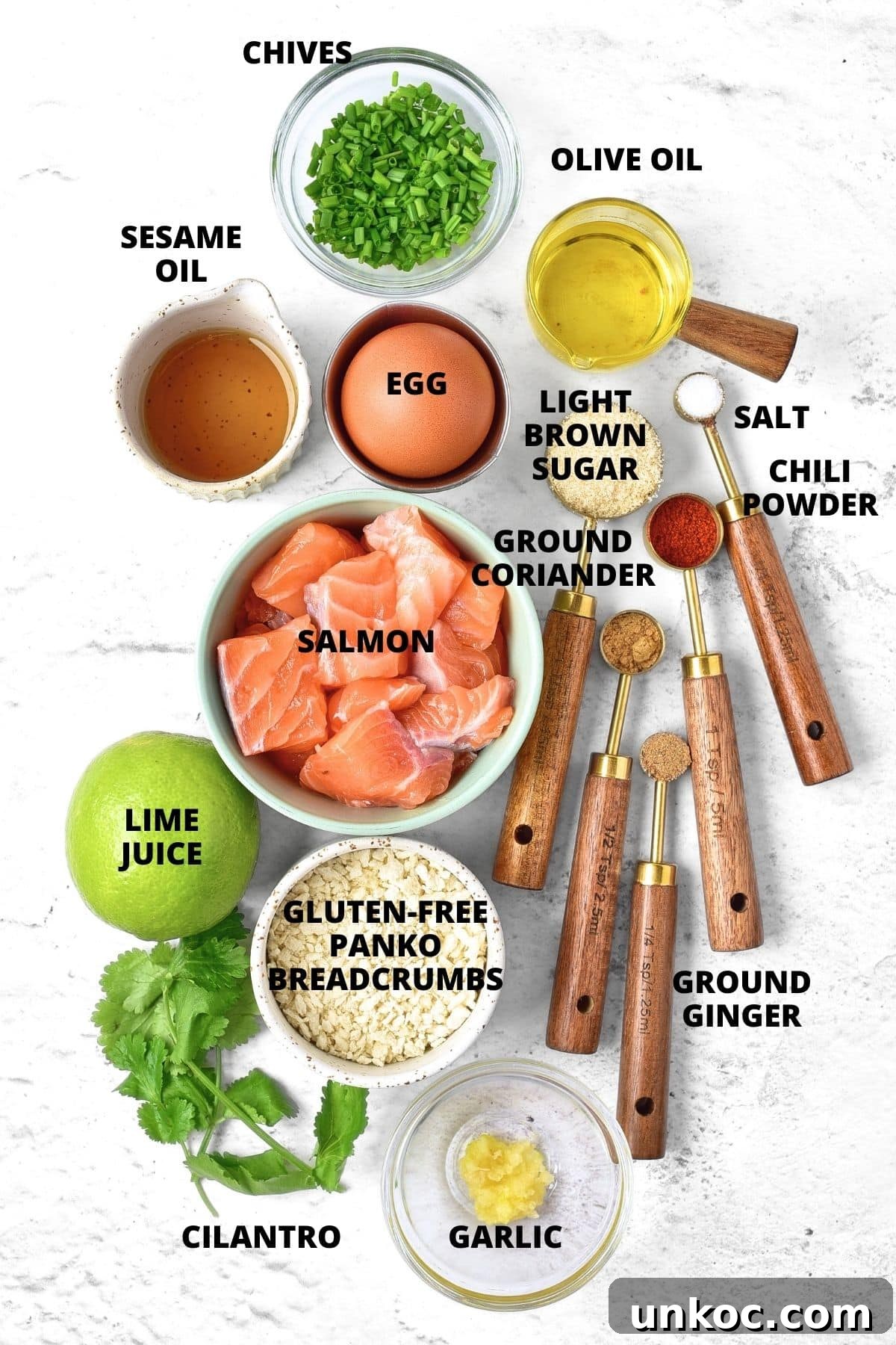 Ingredients for Thai salmon cakes recipe laid out on marble board.