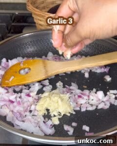 Jaffna Eggplant Chickpea Curry Sri Lankan Brinjal Recipe 16 Sautéing onions and garlic for Jaffna brinjal curry in a skillet.