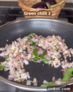 Jaffna Eggplant Chickpea Curry Sri Lankan Brinjal Recipe 20 Delicious Sri Lankan brinjal curry with sautéed onions and green chilies in a frying pan.