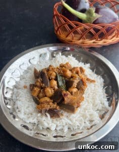 Jaffna Eggplant Chickpea Curry Sri Lankan Brinjal Recipe 3 Delicious Sri Lankan brinjal curry served over white rice, featuring eggplant and chickpeas in flavo.