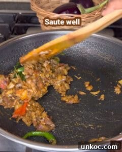Jaffna Eggplant Chickpea Curry Sri Lankan Brinjal Recipe 26 Jaffna brinjal curry cooking in a pan with spices and vegetables.
