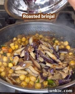 Jaffna Eggplant Chickpea Curry Sri Lankan Brinjal Recipe 33 Close-up of roasted brinjal and chickpeas curry in a pan, Sri Lankan style.