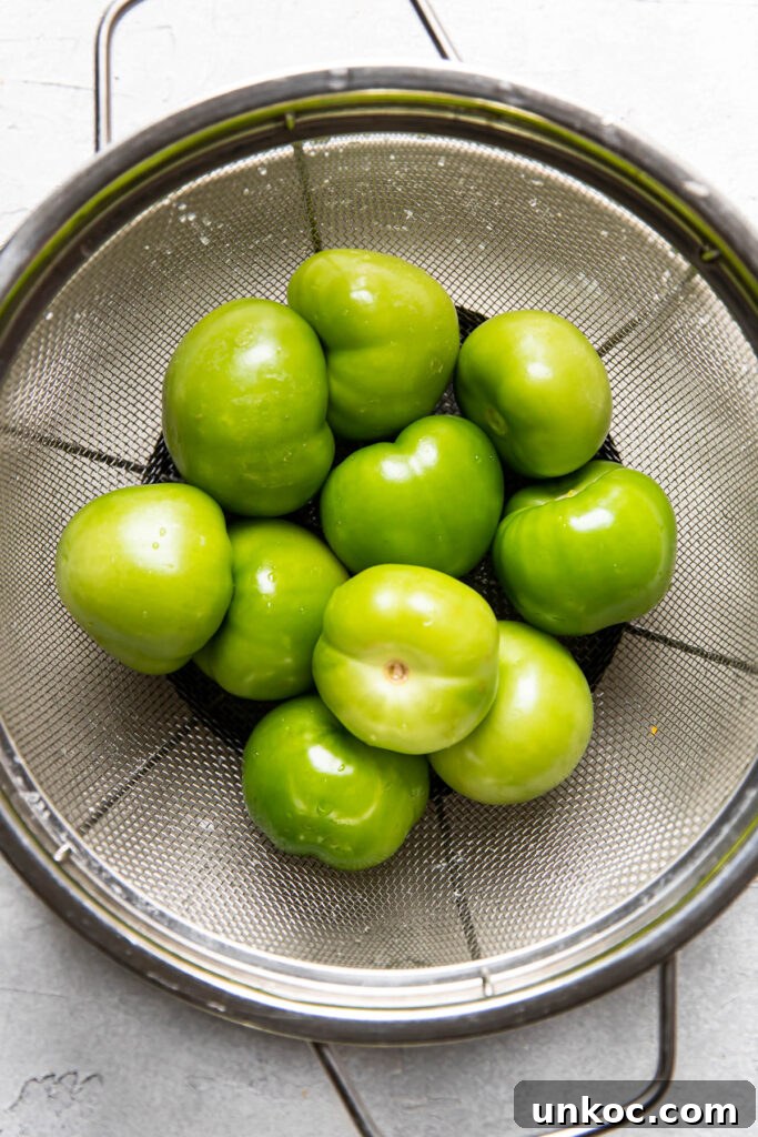 clean tomatillos in a colander.